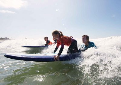 Young surfers catch wave at Malibu Makos