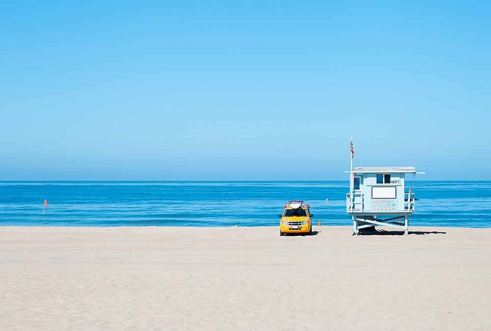 Lifeguard station on beach with yellow car